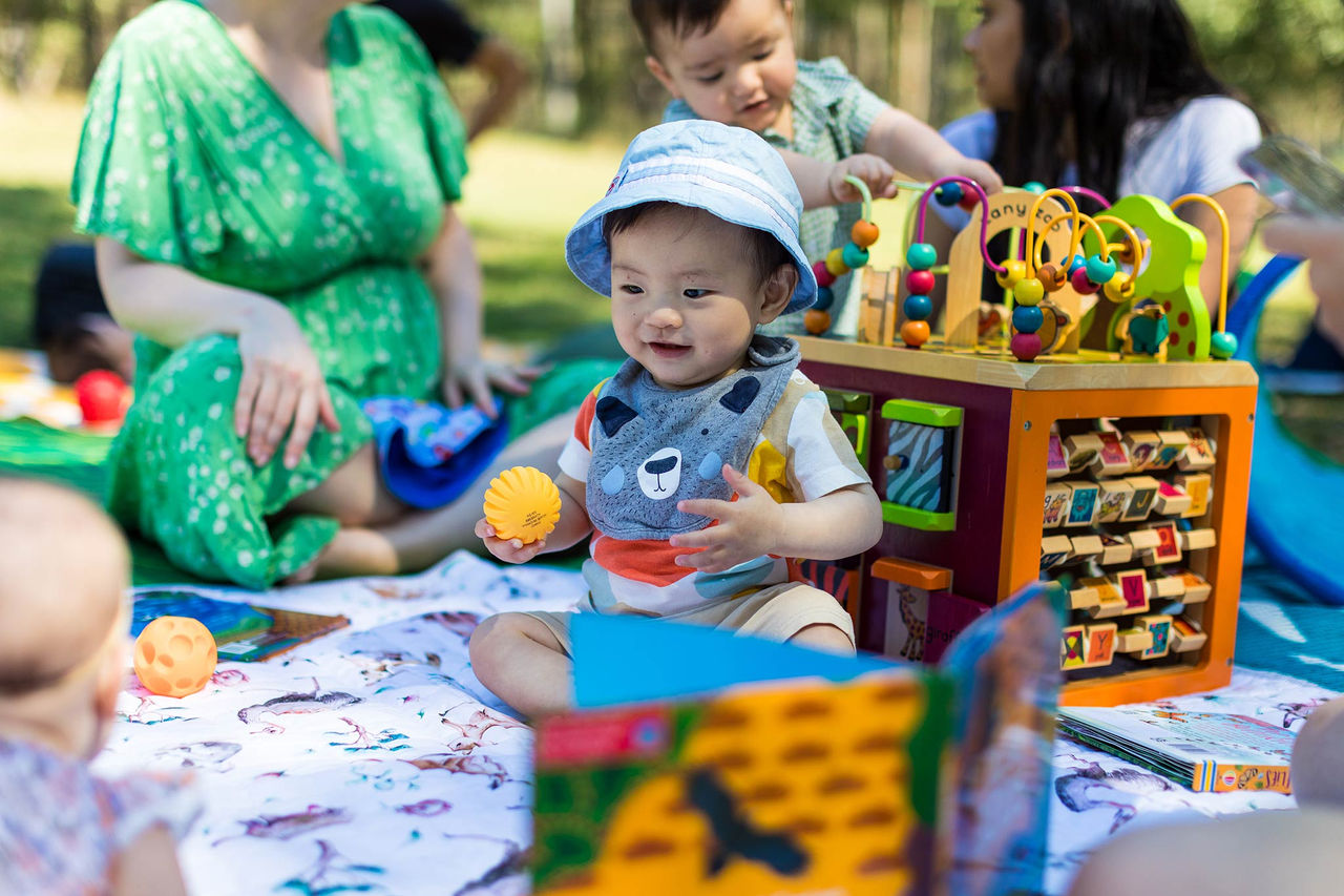 A young toddler playing on a mat at a Bush Babies events at Karawatha Forest.