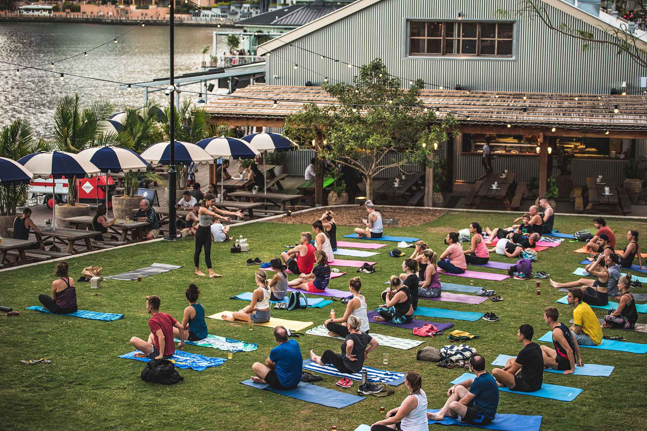 People doing outdoors yoga at Howard Smith Wharves.