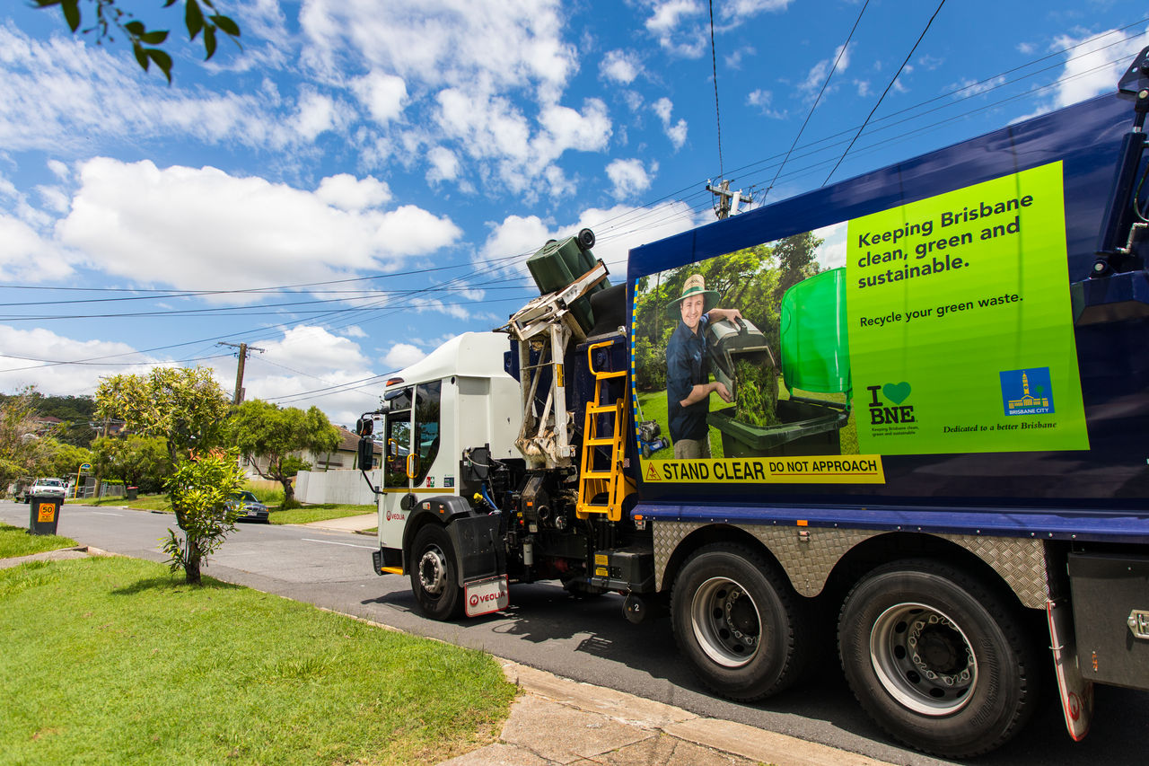 Council food waste recycling service truck picking up a bin.