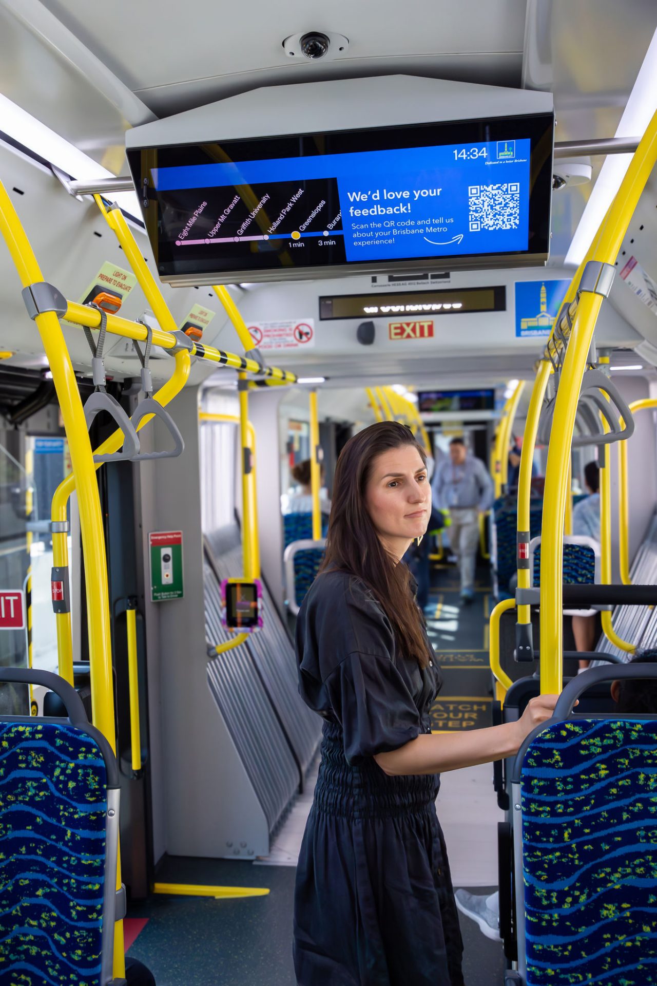 Female passenger standing on a Metro vehicle.