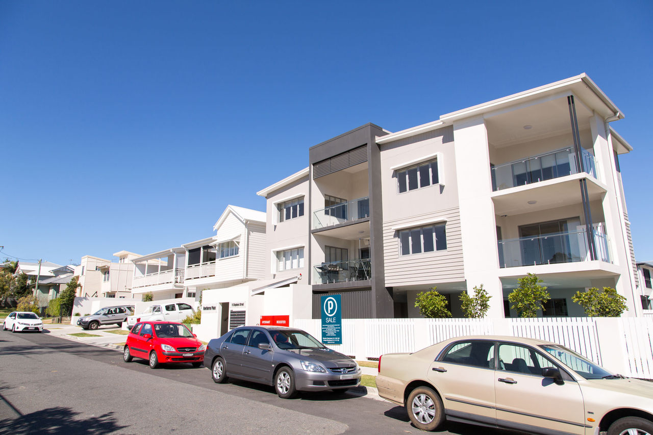 Apartment buildings along a street at Bulimba as seen from the road.