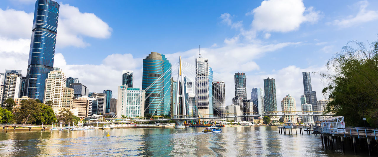 Kangaroo Point Bridge as seen from the Brisbane River with the city skyline in the background.