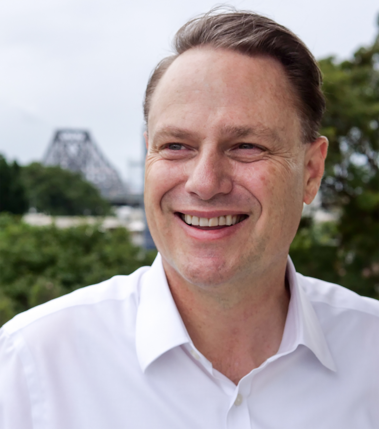 Headshot image of the Lord Mayor with the Story Bridge in the background.