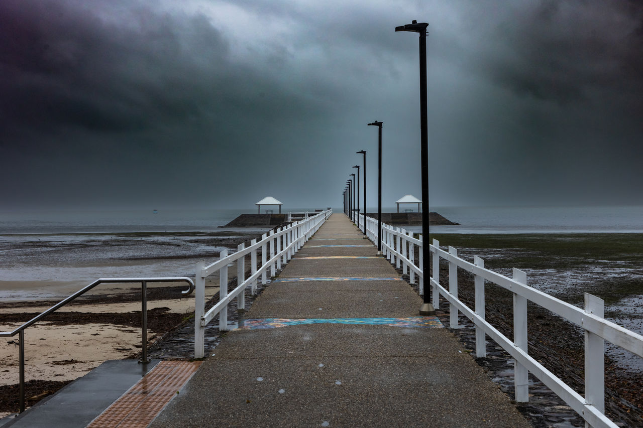 Ominous, dark-coloured storm clouds rolling in above Wynnum Jetty, Wynnum.
