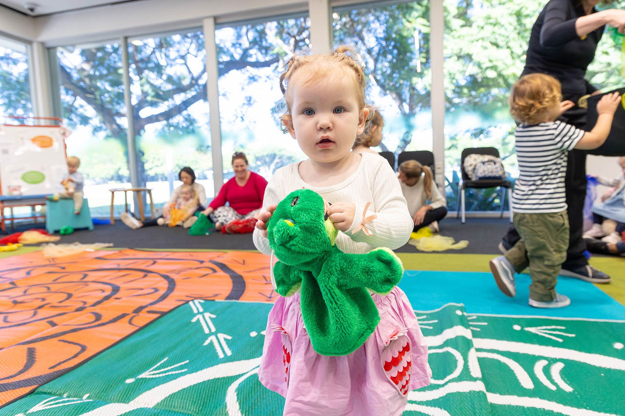 Toddler in a pink dress at First 5 Forever at New Farm Library.