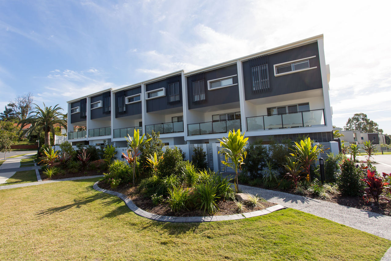 Three-storey townhouses with balconies and flat roofs at Clearview Urban Village.
