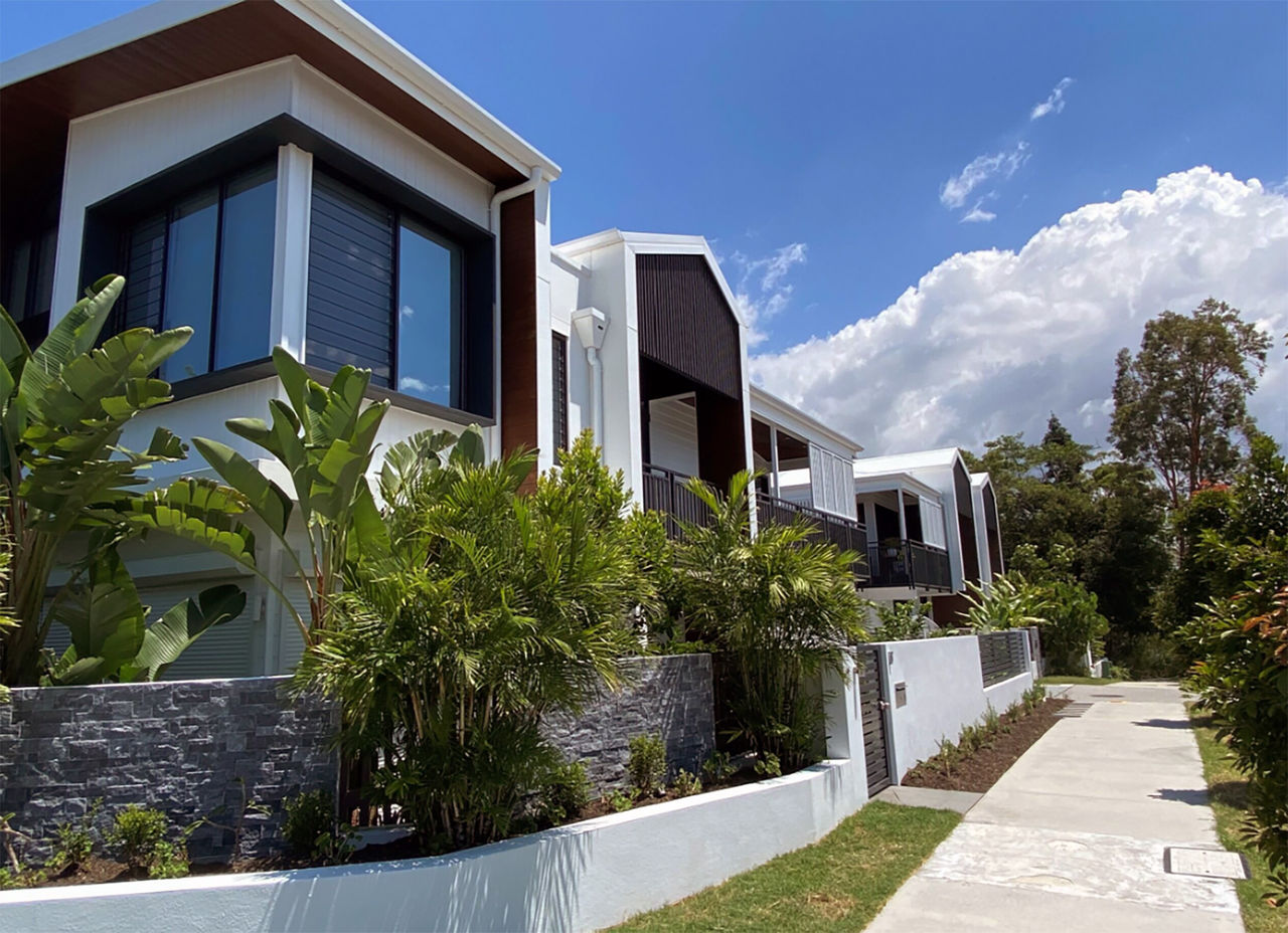 Part of a streetscape with multi-story multi-unit dwellings.