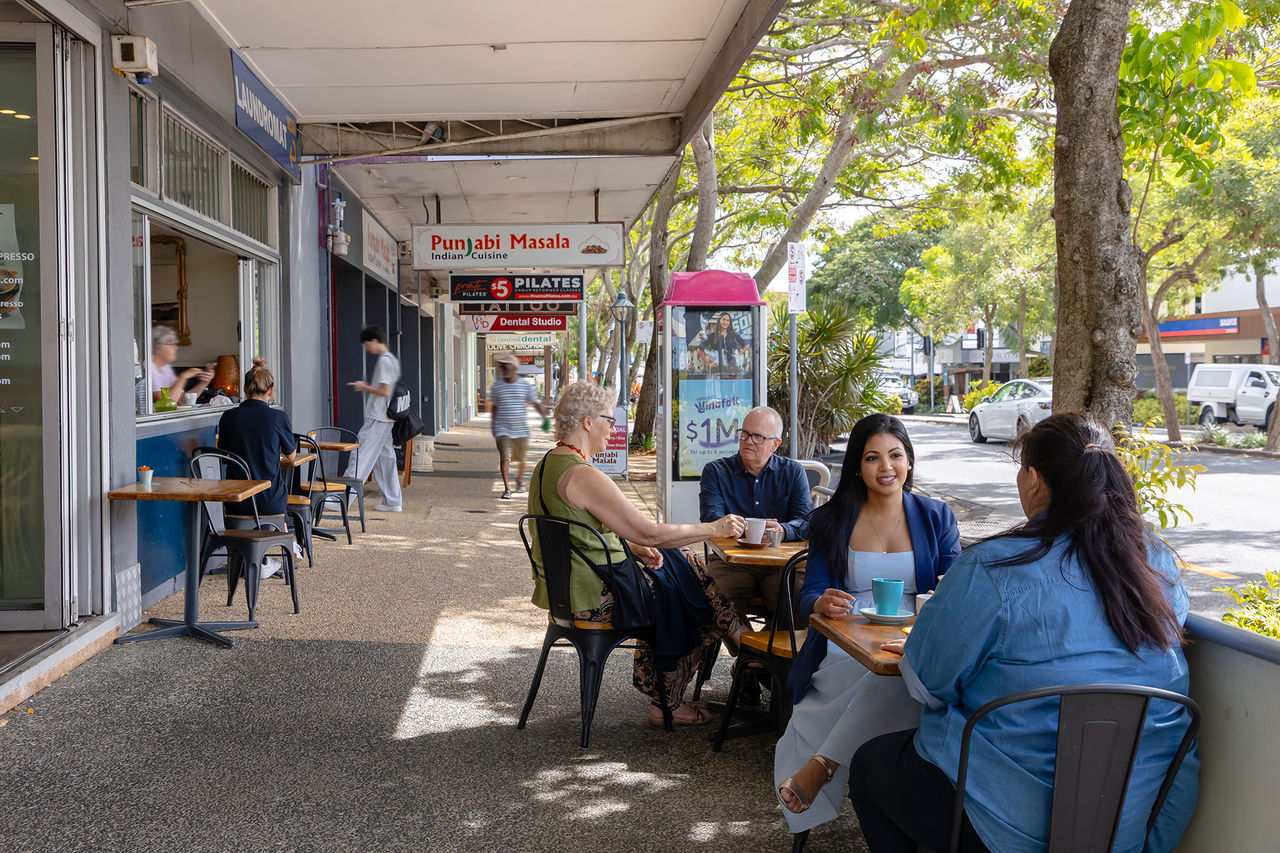 Residents sitting outdoors at cafe tables at Mt Gravatt Centre
