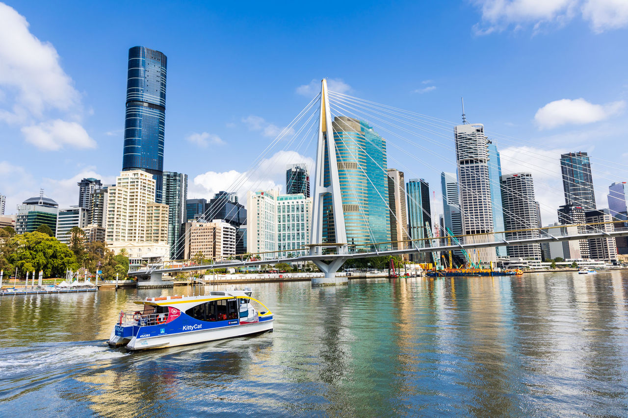A view from Kangaroo Point to the Brisbane CBD with KittyCat on Brisbane River in foreground, Kangaroo Point Bridge in mid section and CBD in background.