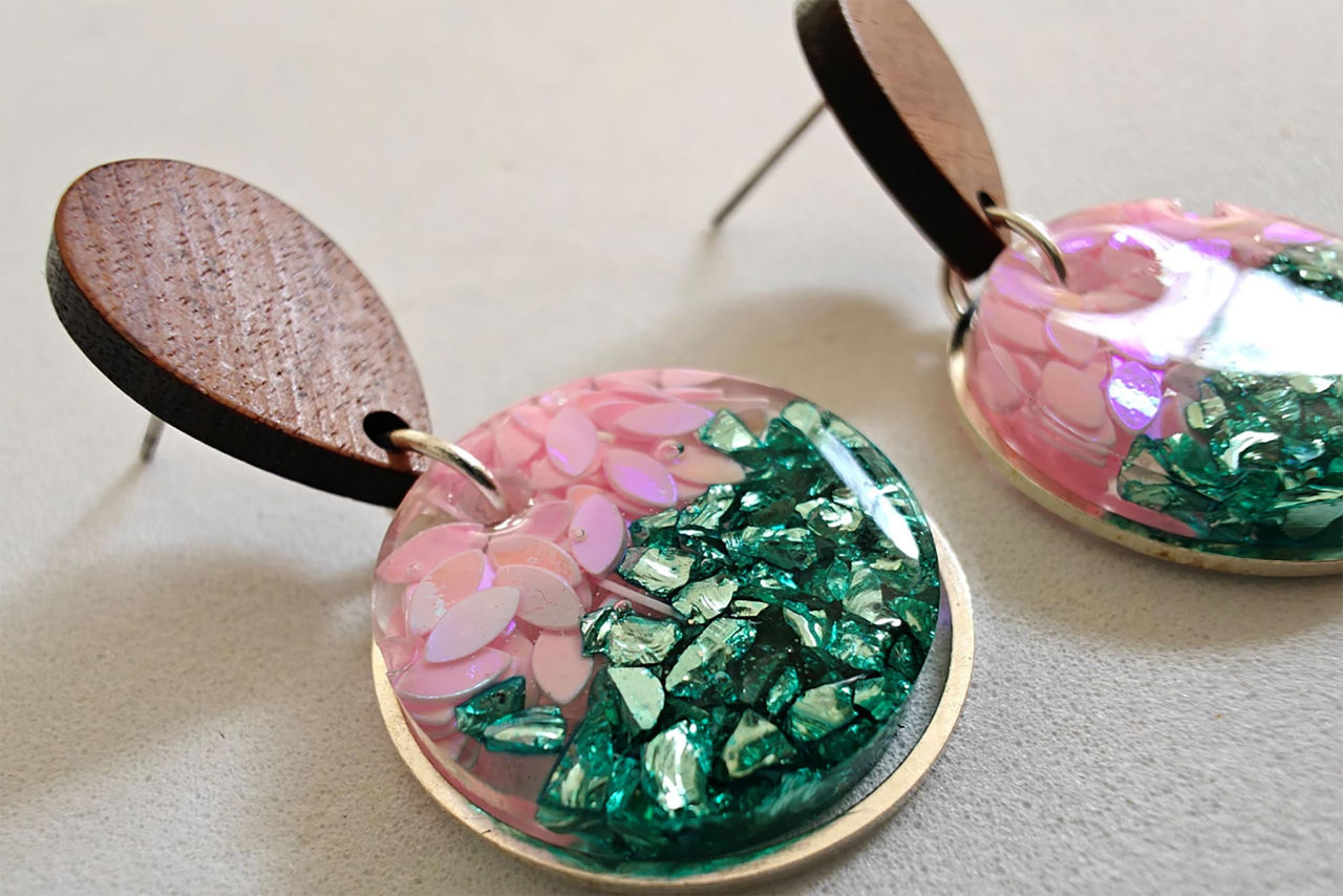 A pair of pink and green dangly earrings by Resinate with Love.