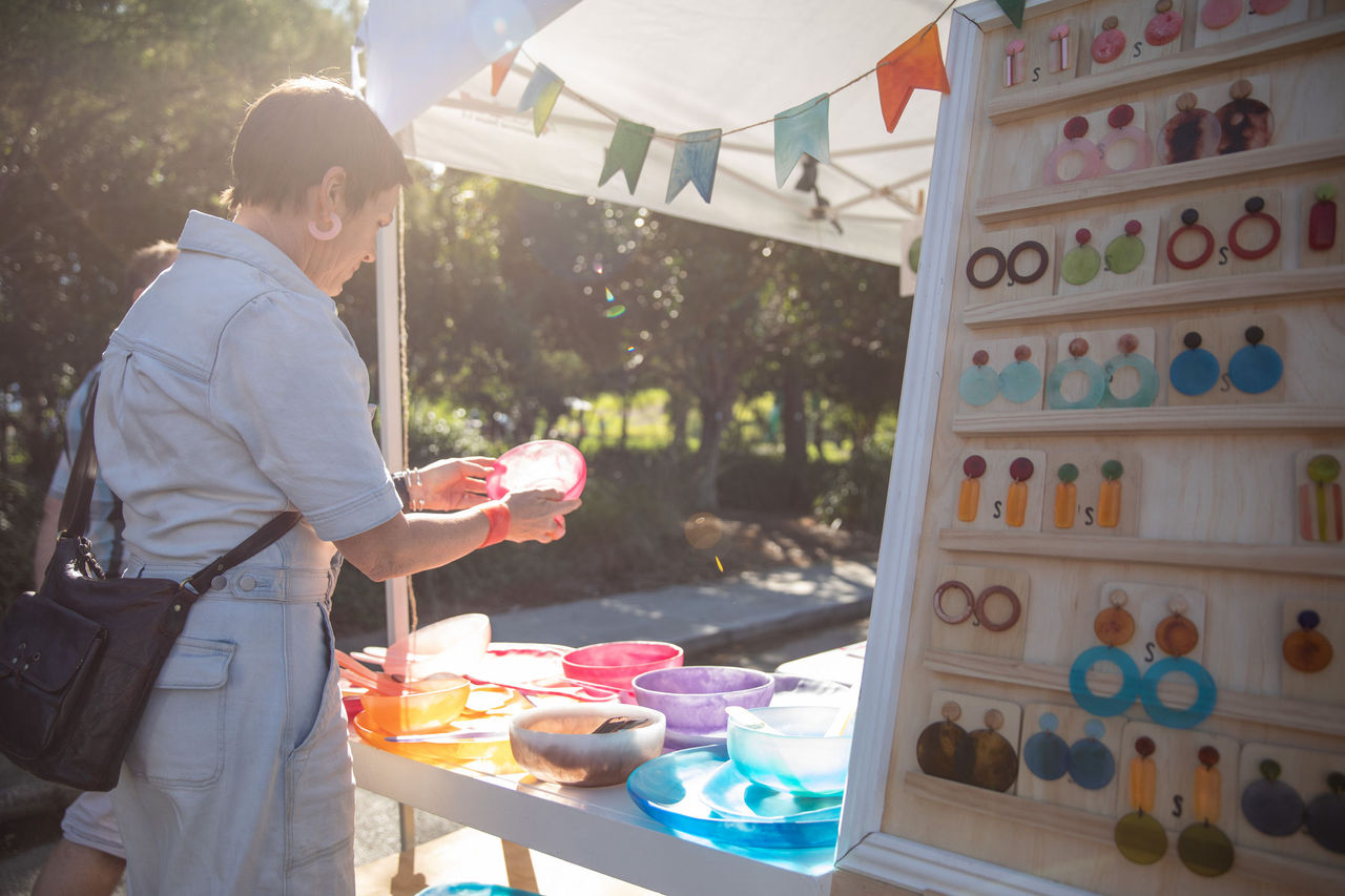 A customer looking at products in a market stall.