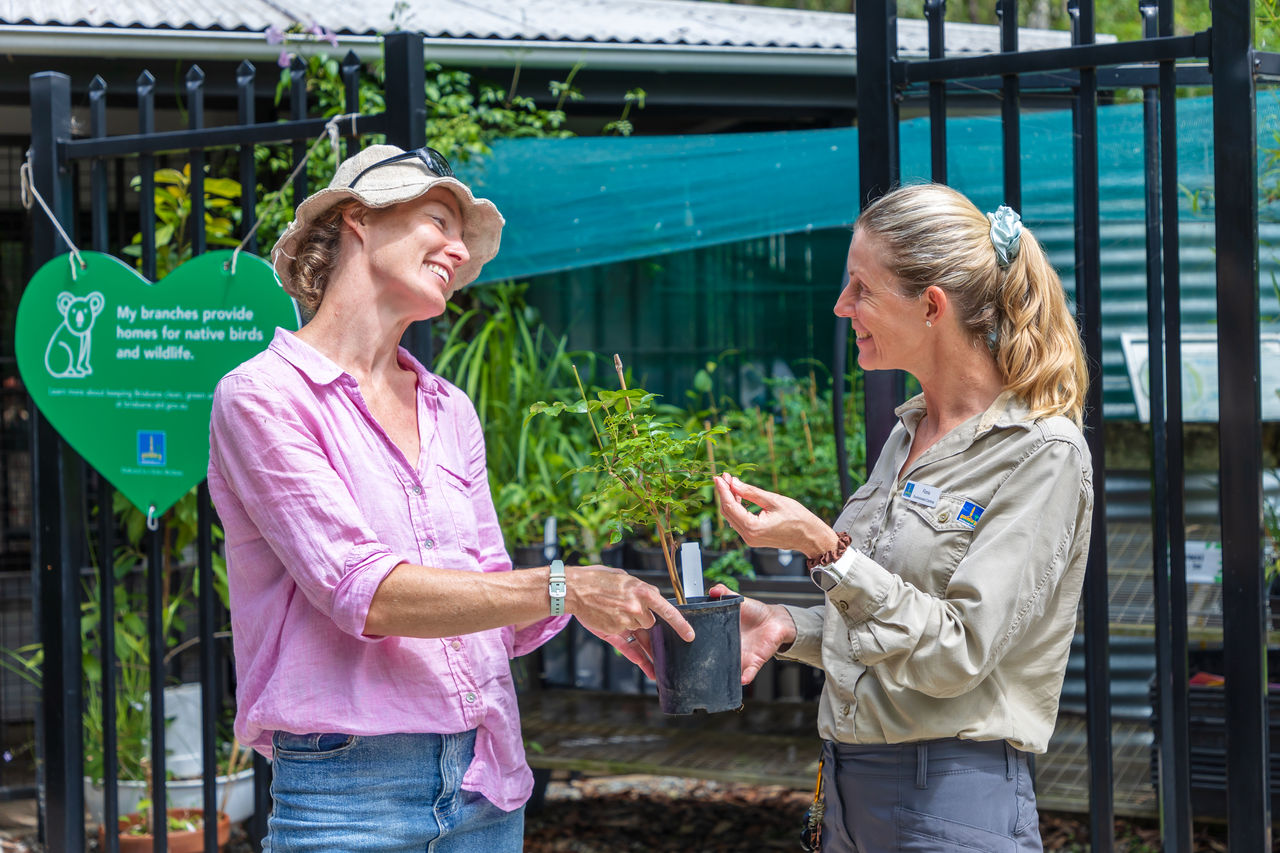 Female midde-aged resident receiving free native plant advice from a Council officer at Downfall Creek Bushland Centre.