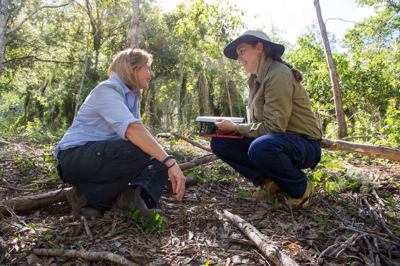 Female landholder sitting on her property talking with a female Council officer about the Wildlife Conservation Partnership Program.