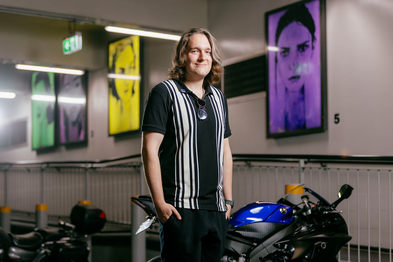 Frazer Campbell in front of his artworks for the AMPLIFY ME! Outdoor Gallery exhibition.
