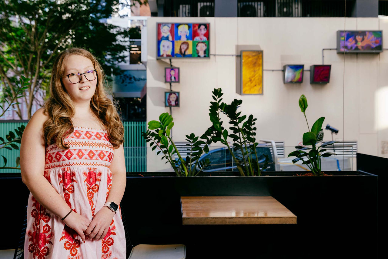 Artist May Washington with her artworks included in the AMPLIFY ME! Outdoor Gallery exhibition.