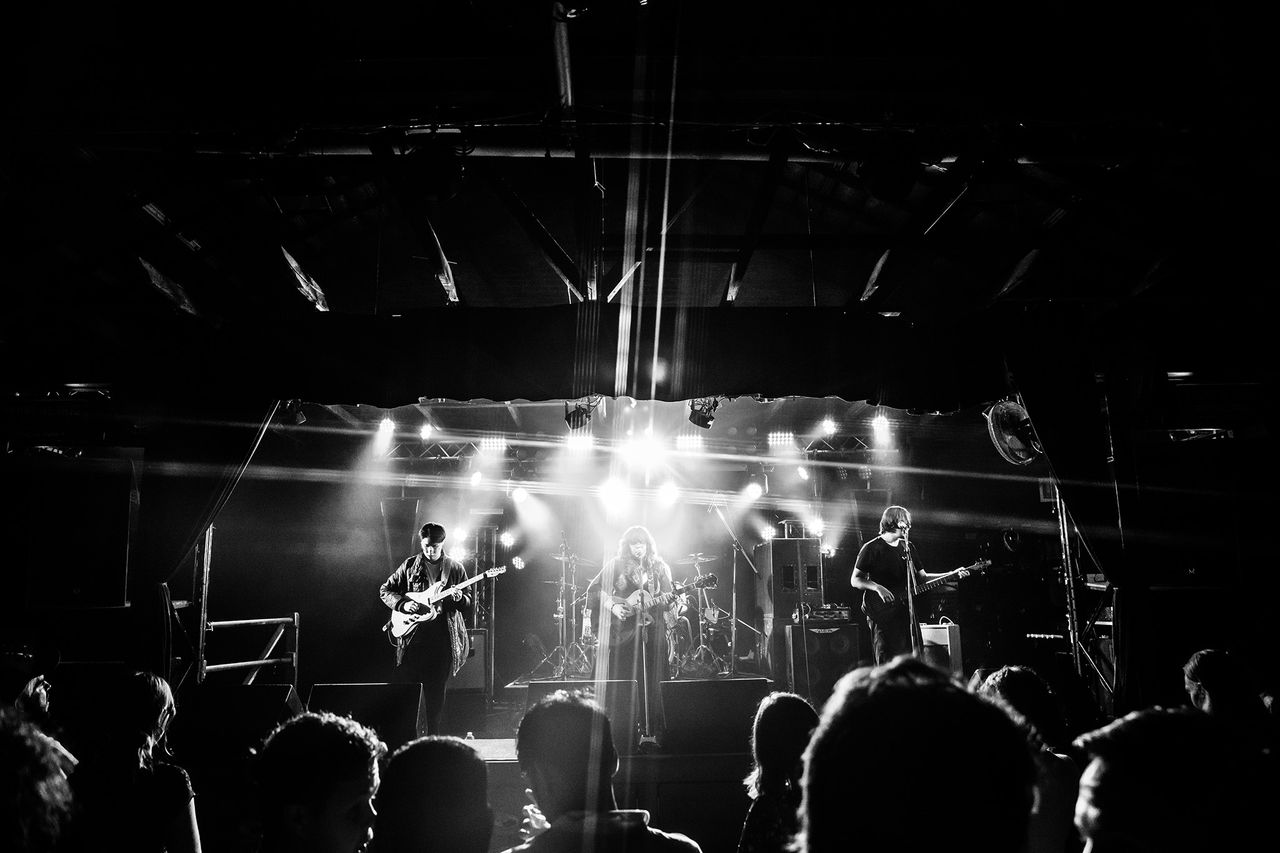 The QUBE finalist neish playing music on stage.