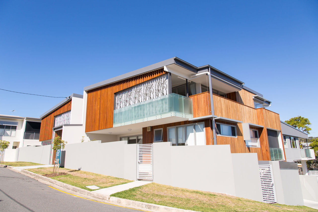 Multi-unit dwelling in Bulimba. Multi-material finish including glass, and timber.