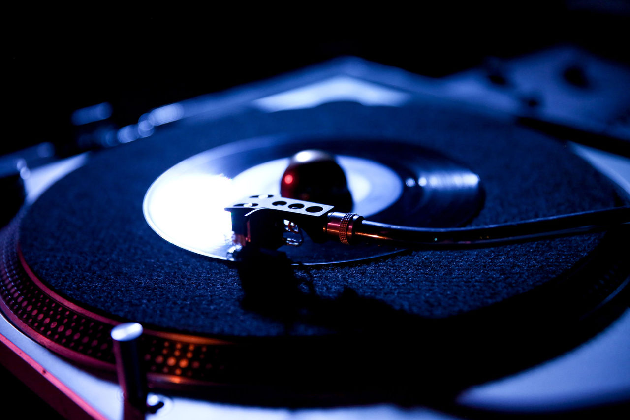 DJ turntable under blue-ish light.