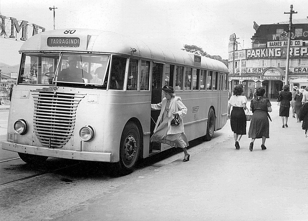 Historic photo of female passenger boarding no. 80 Tarragindi-bound bus.
