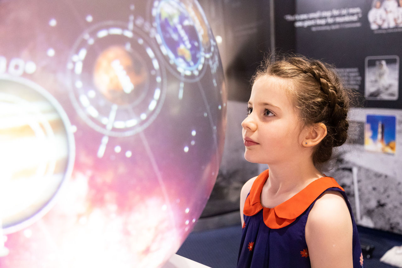 Young girl in Display Zone at Sir Thomas Brisbane Planetarium.