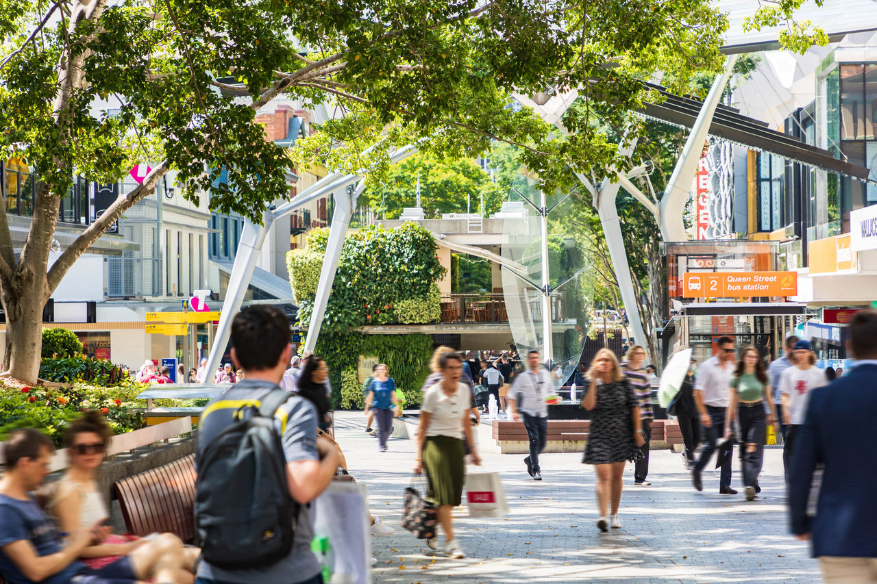 People walking in the mid-section of the Queen Street Mall.