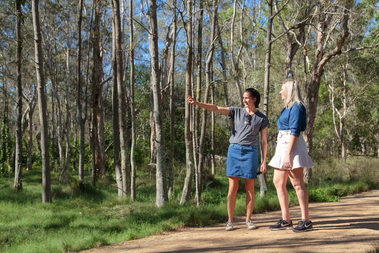 Two women on a walking along a bush track in Boondall Wetlands.