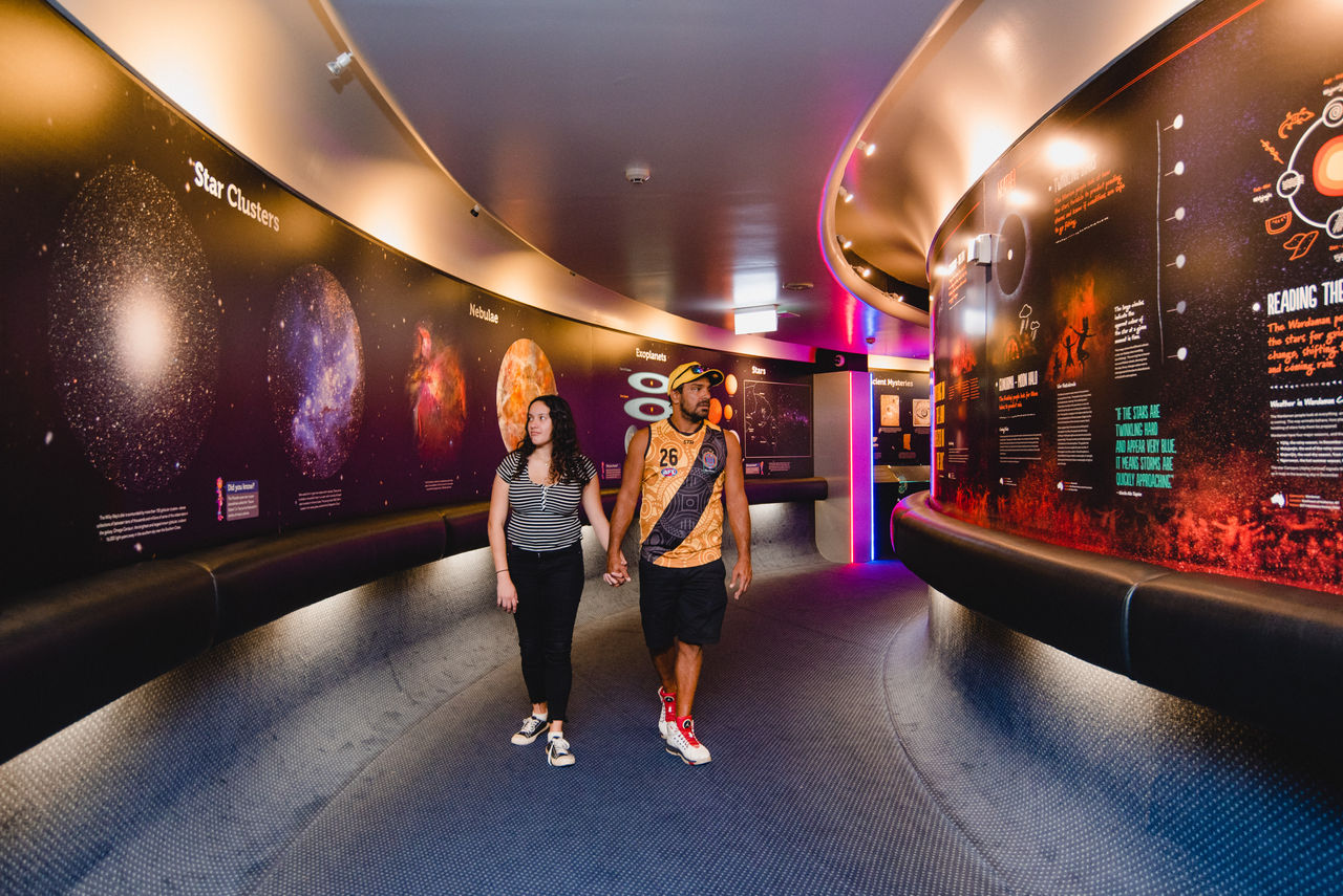 Couple walking through displays at Sir Thomas Brisbane Planetarium.