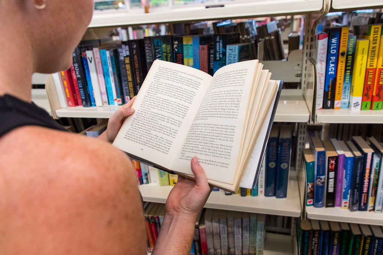 Person reading a book at the Mt Coot-tha Library.