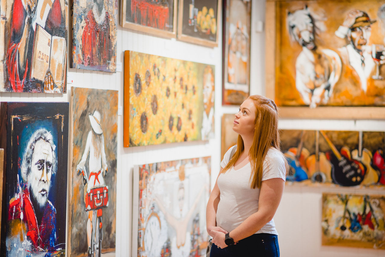 Woman viewing art at Richard Randall Art Studio.