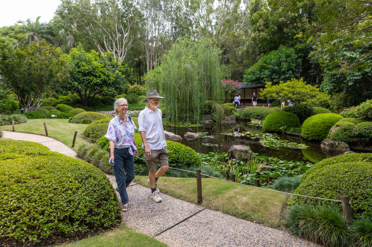 A couple walking in the Japanese garden at Brisbane Botanic Gardens Mt Coot-tha.