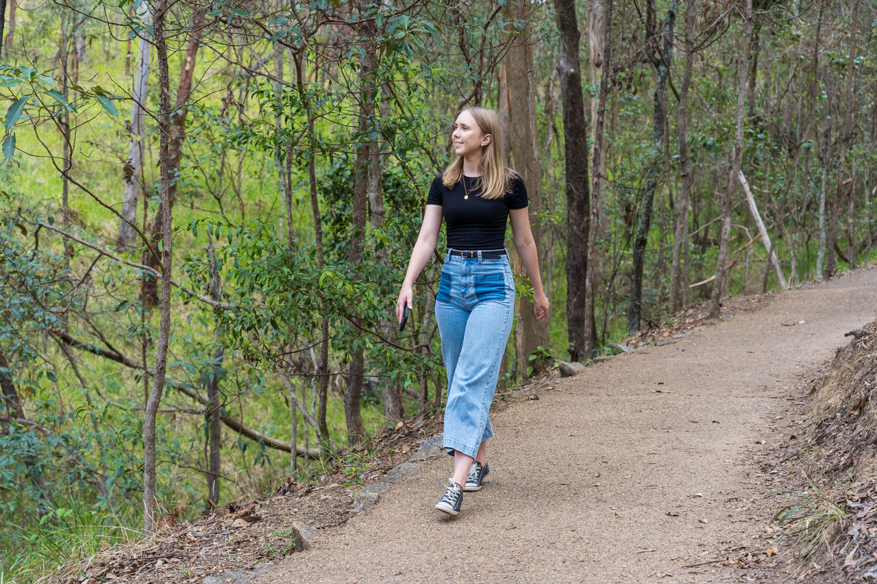 Woman walking a track in Mt Coot-tha Reserve.