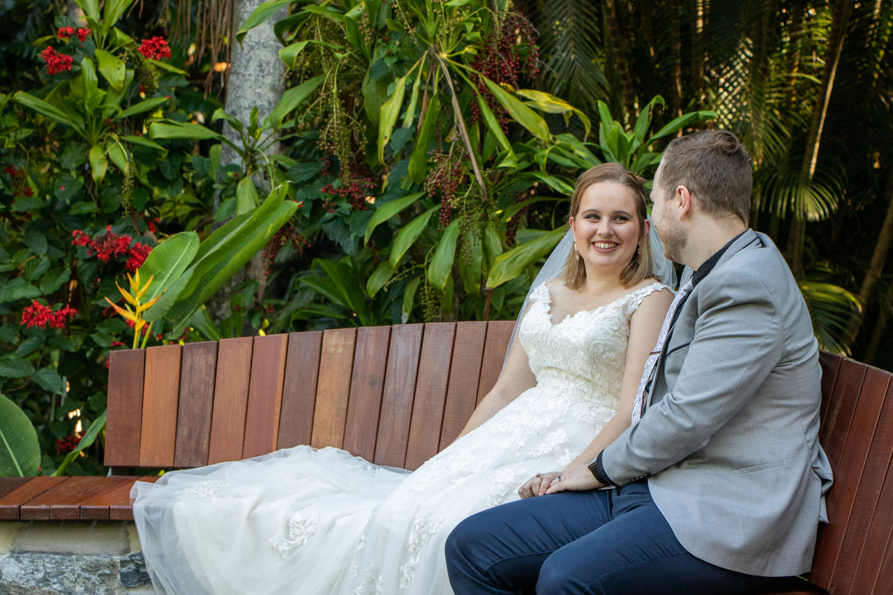 Wedding couple sitting on a wooden seat in a bookable site at Brisbane Botanic Gardens Mt Coot-tha.