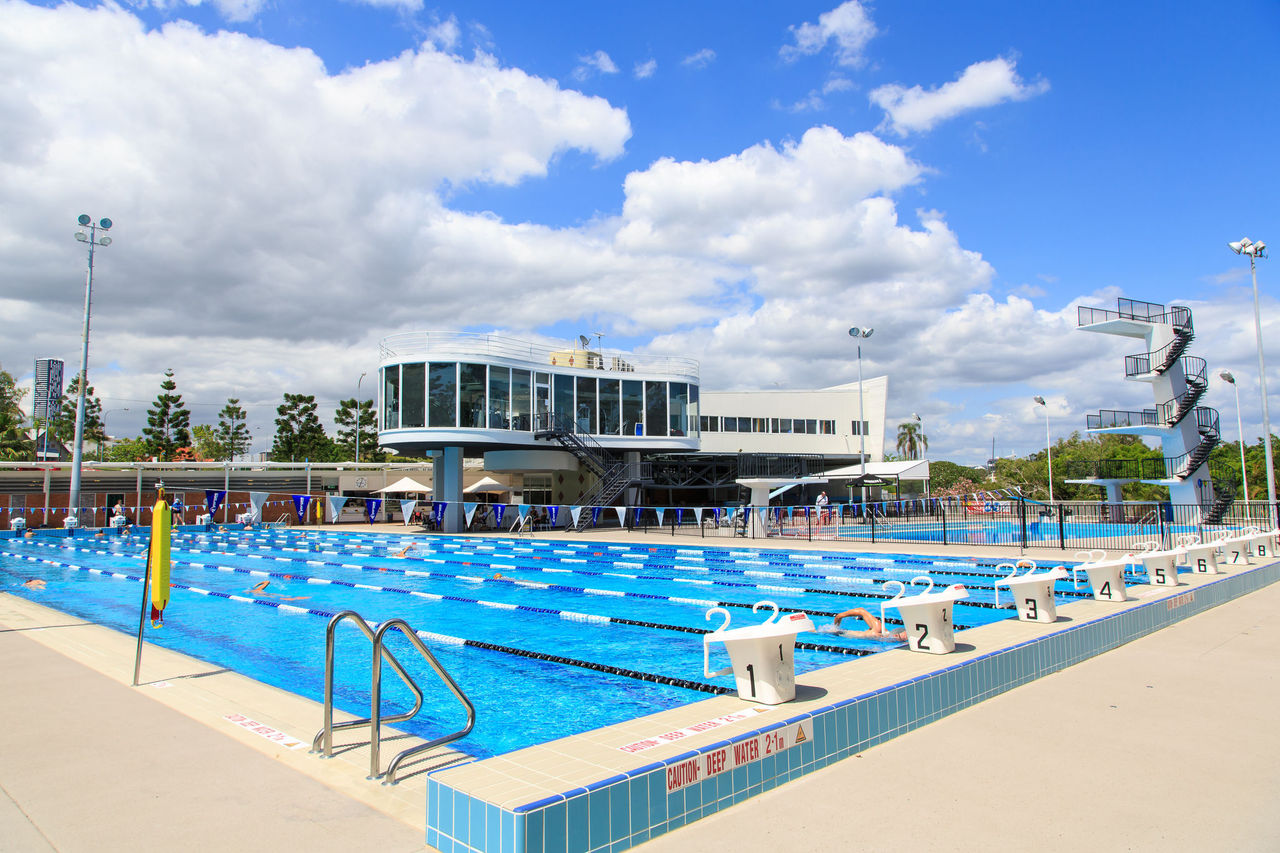Looking across the 50-metre outdoor pool tot he Centenary Pool building and dive tower.