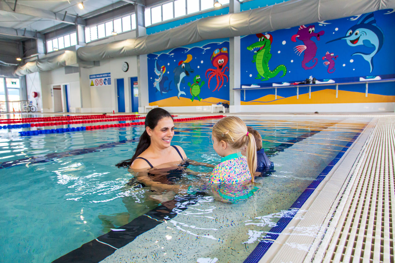 Mother and daughter swimming in the indoor pool at Sandgate Aquatic Centre.