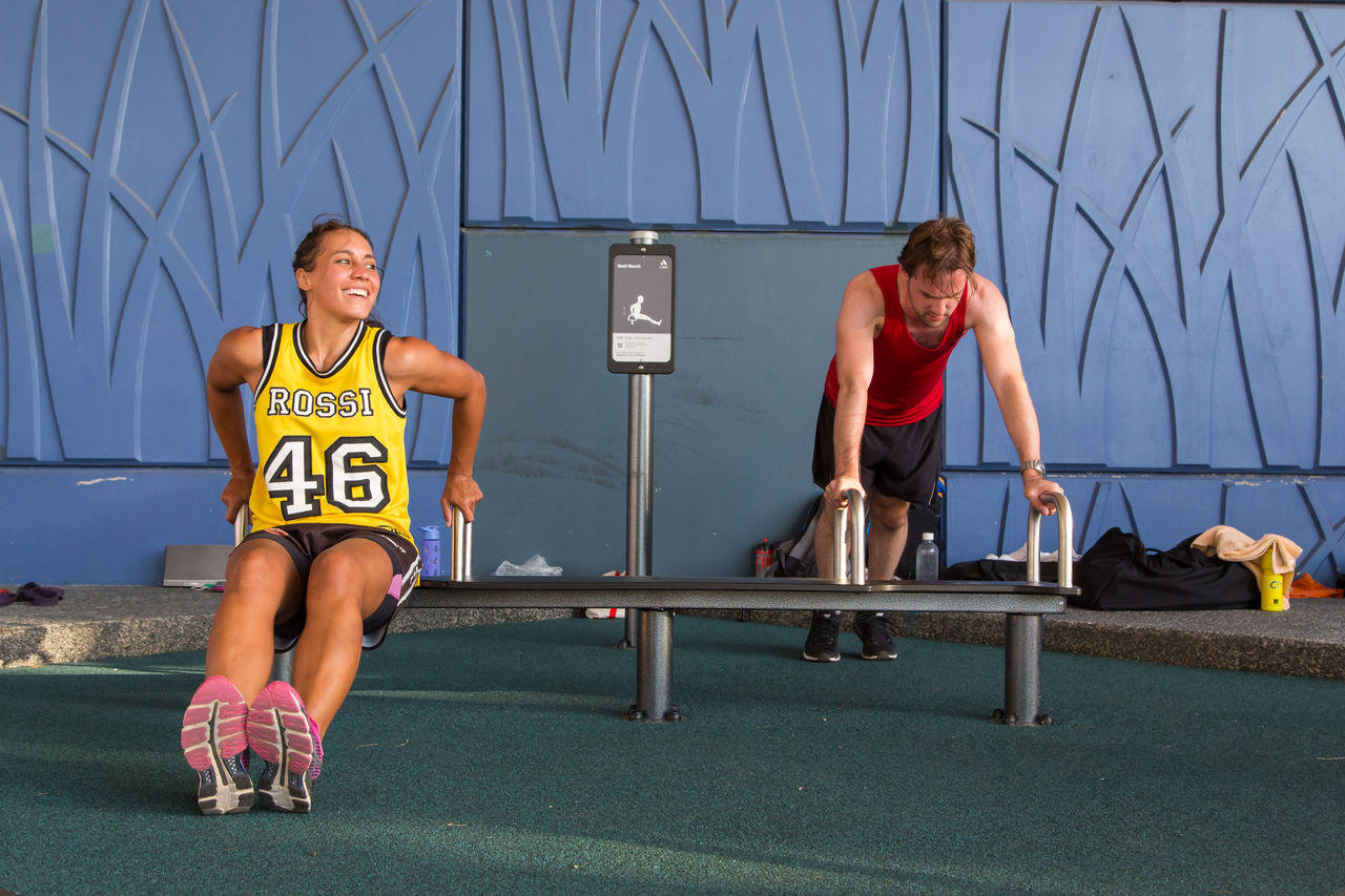 People exercising at an outdoor gym.