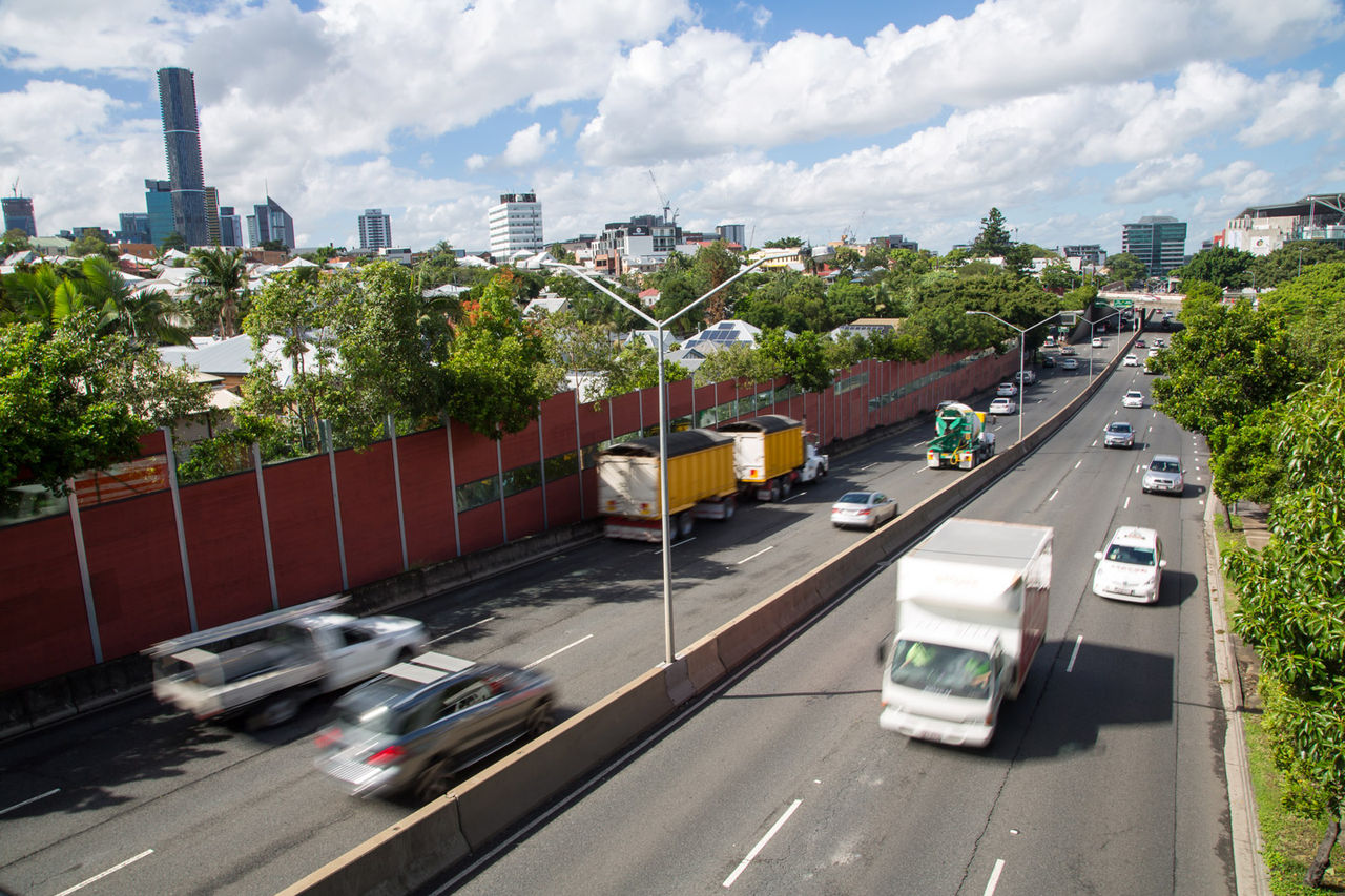Vehicles travelling in both directions on the Inner City Bypass. Brisbane CBD in background.