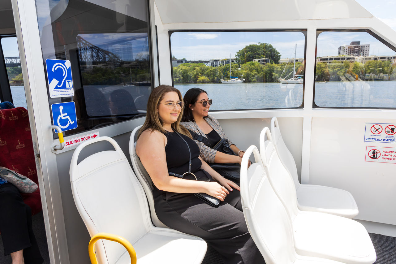 2 female passengers on a CityCat open deck.