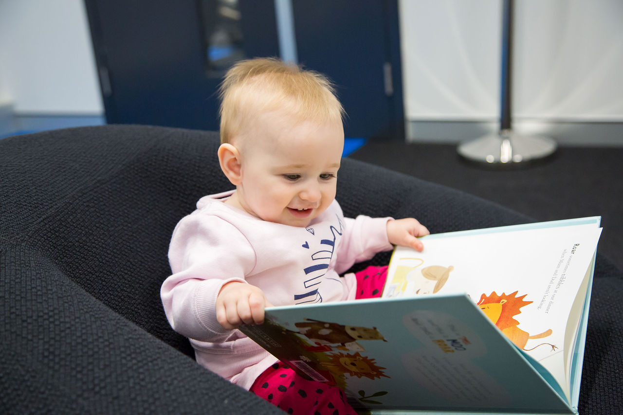 Baby with a picture book at Garden City Library.