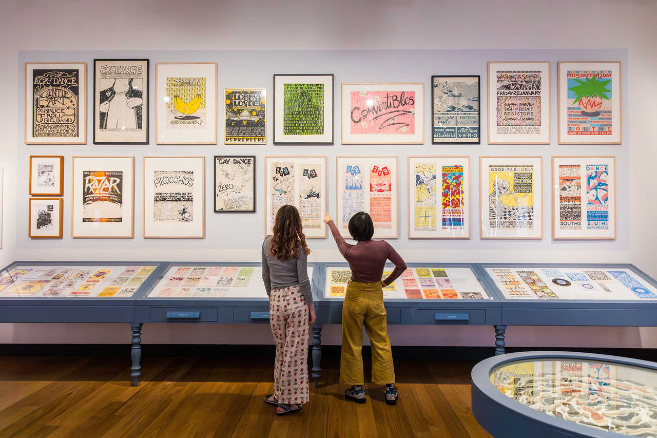 Two women looking at artwork at the Museum of Brisbane.