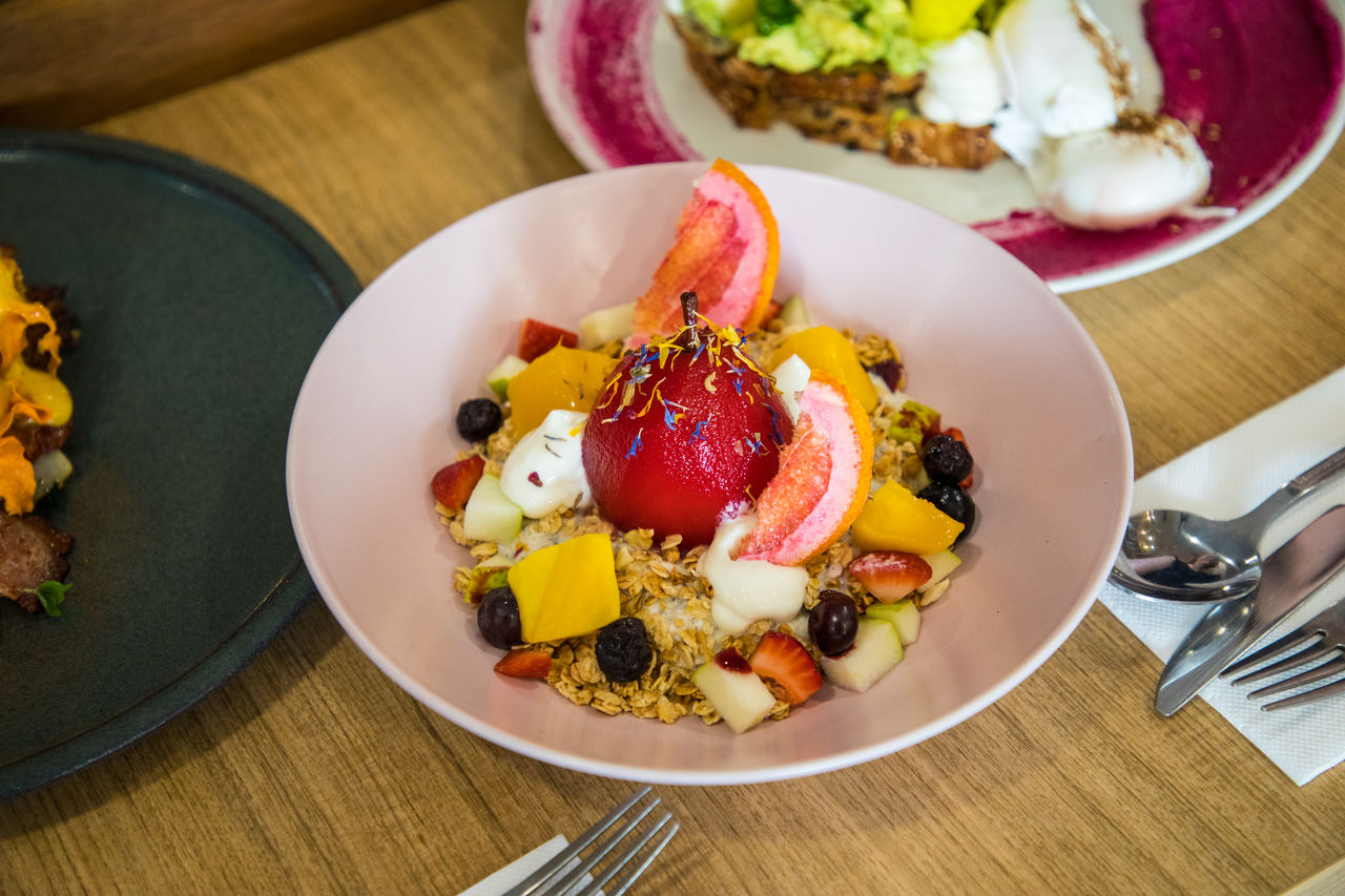 Bowl of granola with poached fruit served in a Brisbane cafe.