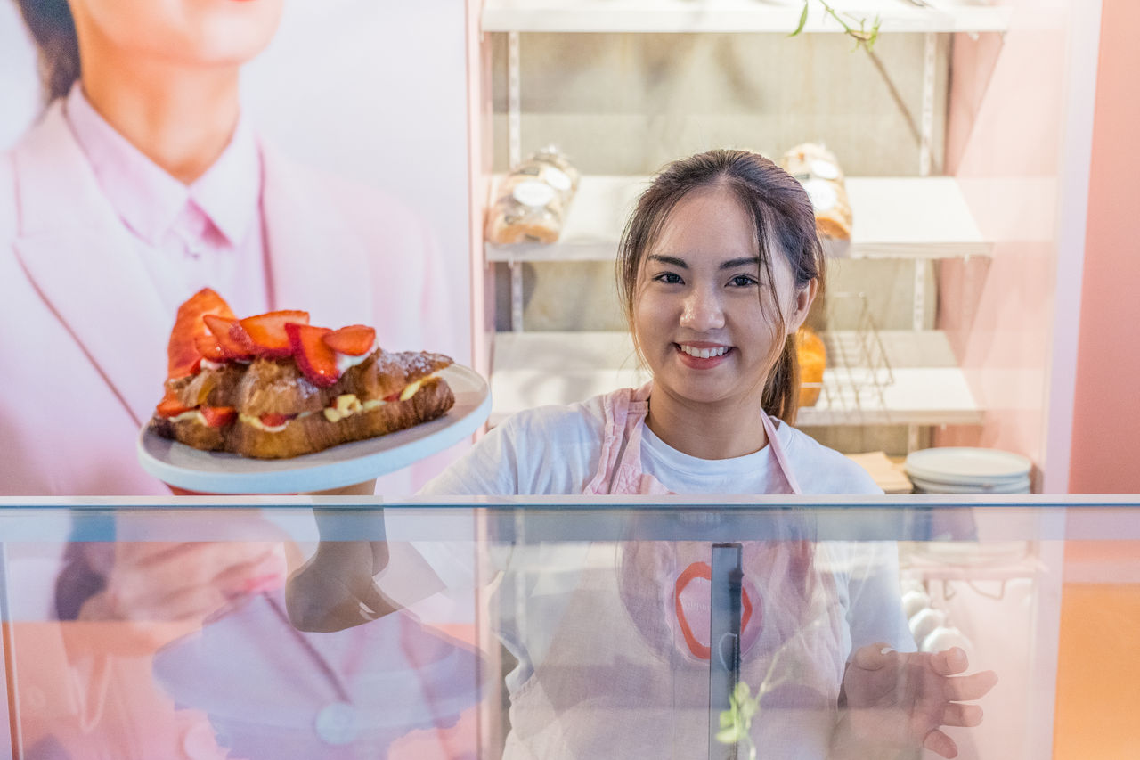 Lady serving in food business.