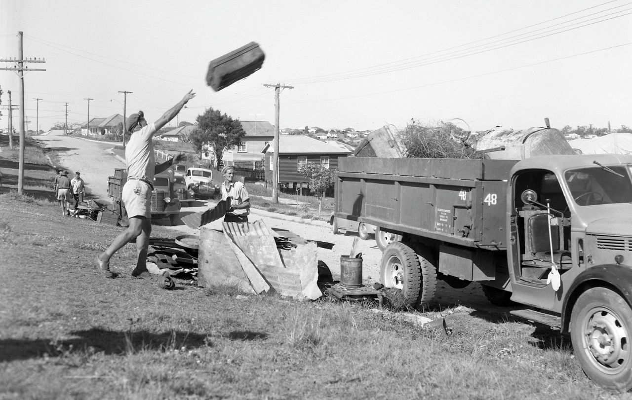 Men throw rubbish into the back of a truck for Council’s first hard rubbish (kerbside) collection.
