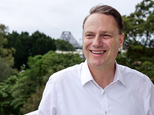Lord Mayor Adrian Schrinner with trees and view of Story Bridge behind