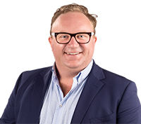 Portrait of Councillor Andrew Wines looking at camera.