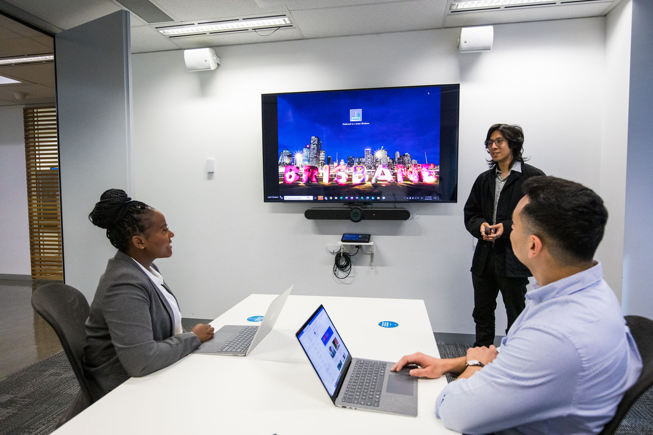 Council office-based staff collaborating in a Council meeting room.