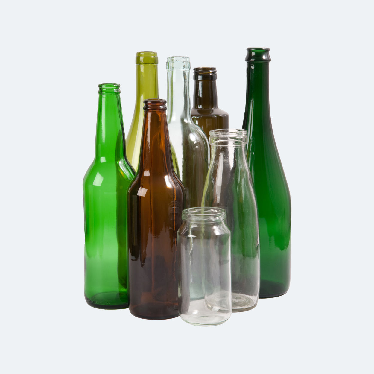 A group of different coloured glass and bottles.