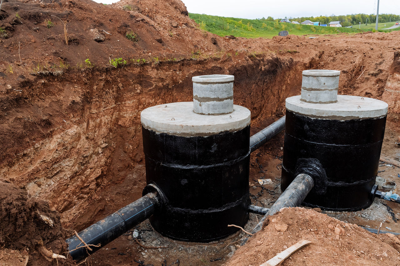 Installation of an on-site sewage facility in an earth trench.