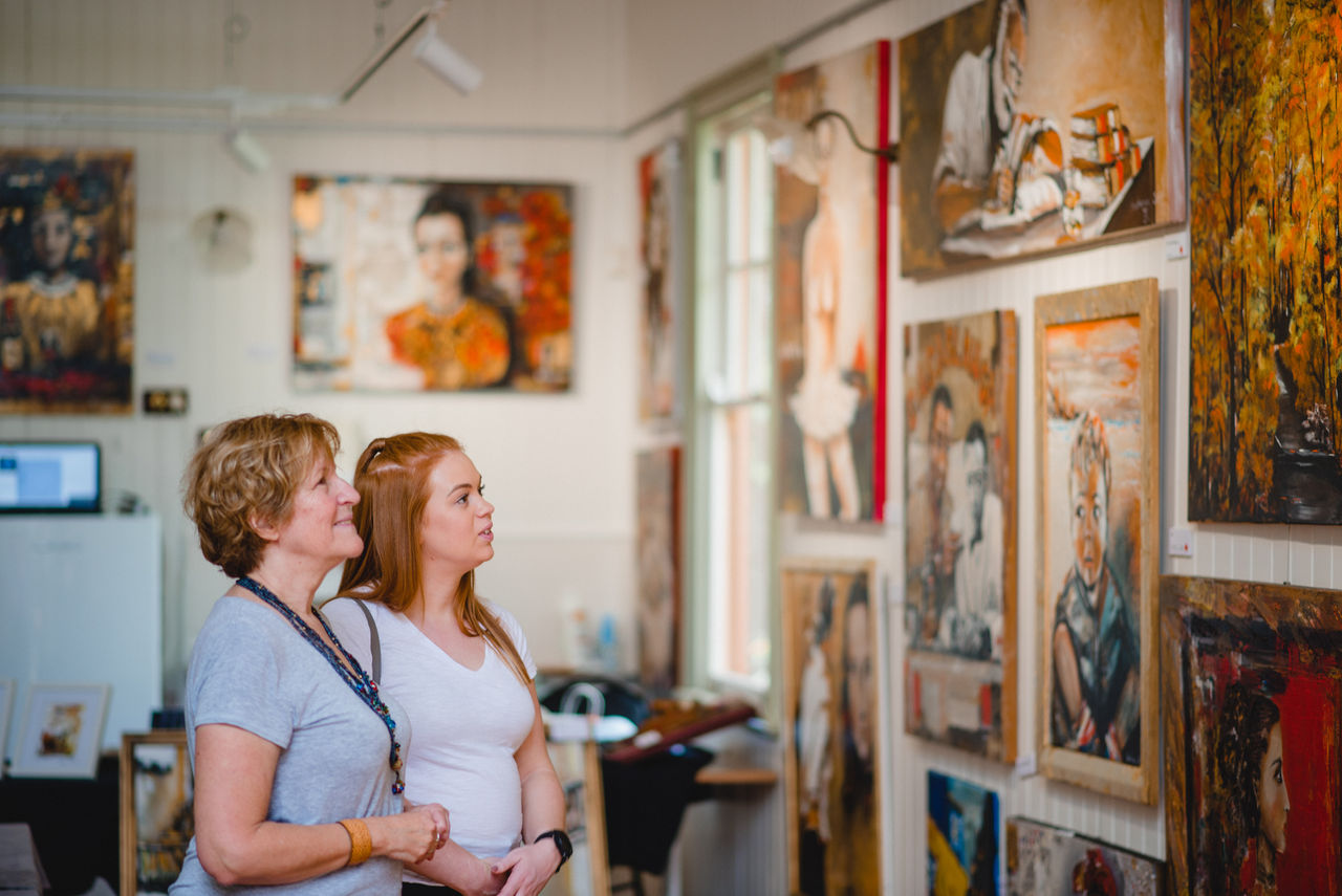 Women looking at art exhibited at Richard Randall Art Studio, Brisbane Botanic Gardens Mt Coot-tha.