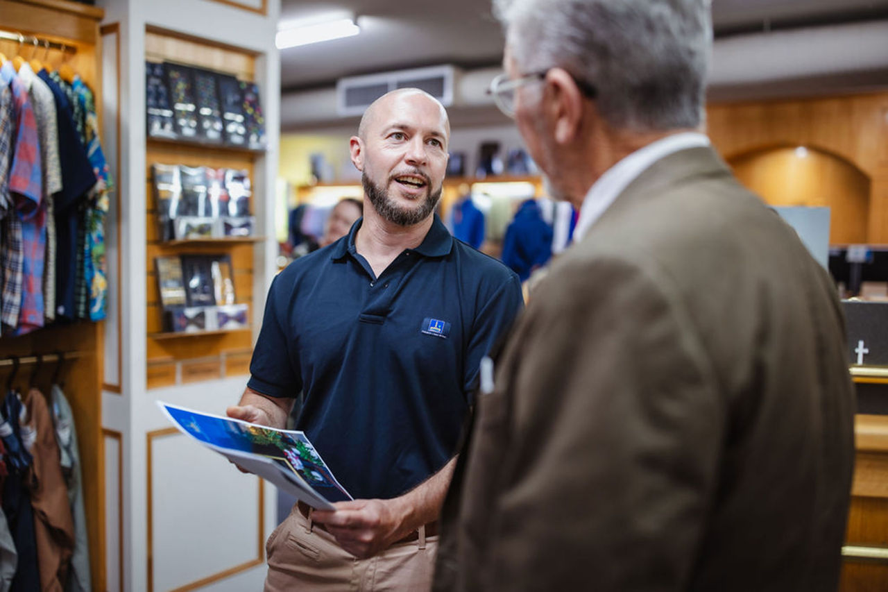 Council officer speaking to a small business owner inside a retail business.