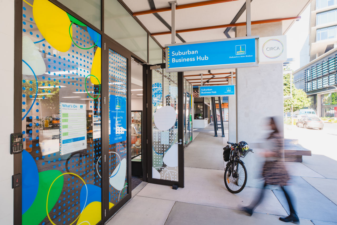 A woman approaches the entrance to Council's Suburban Business Hub in Nundah.
